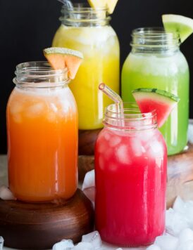 Photo: Four types of aqua fresca including watermelon, cantaloupe, honeydew and pineapple shown in glass mason jars.