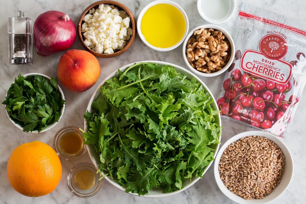Photo: Ingredients used to make a farro, peach, and kale salad shown.