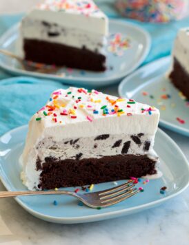 Ice cream cake with chocolate cake, fudge sauce, cookies and cream ice cream and whipped cream topping.