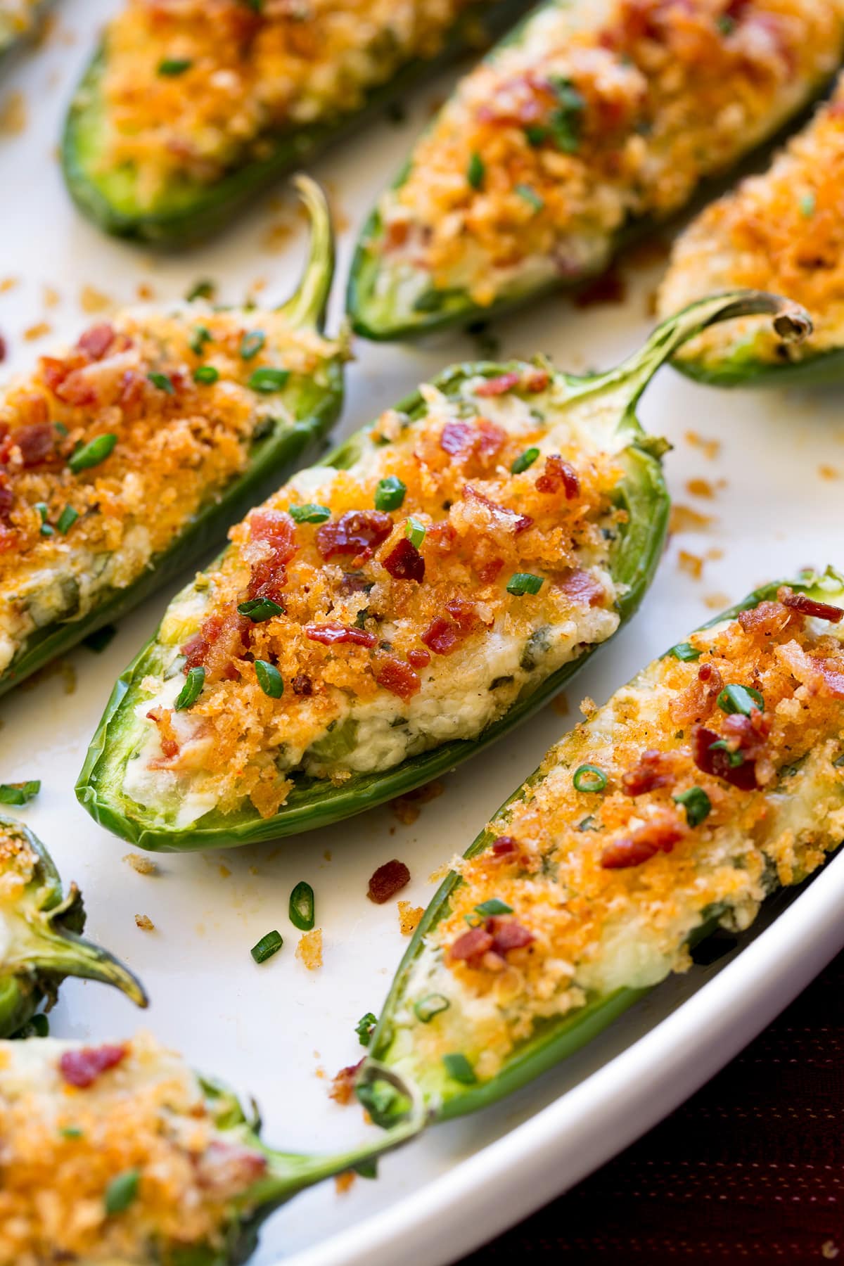 Close up photo of jalapeno poppers on a white serving platter.
