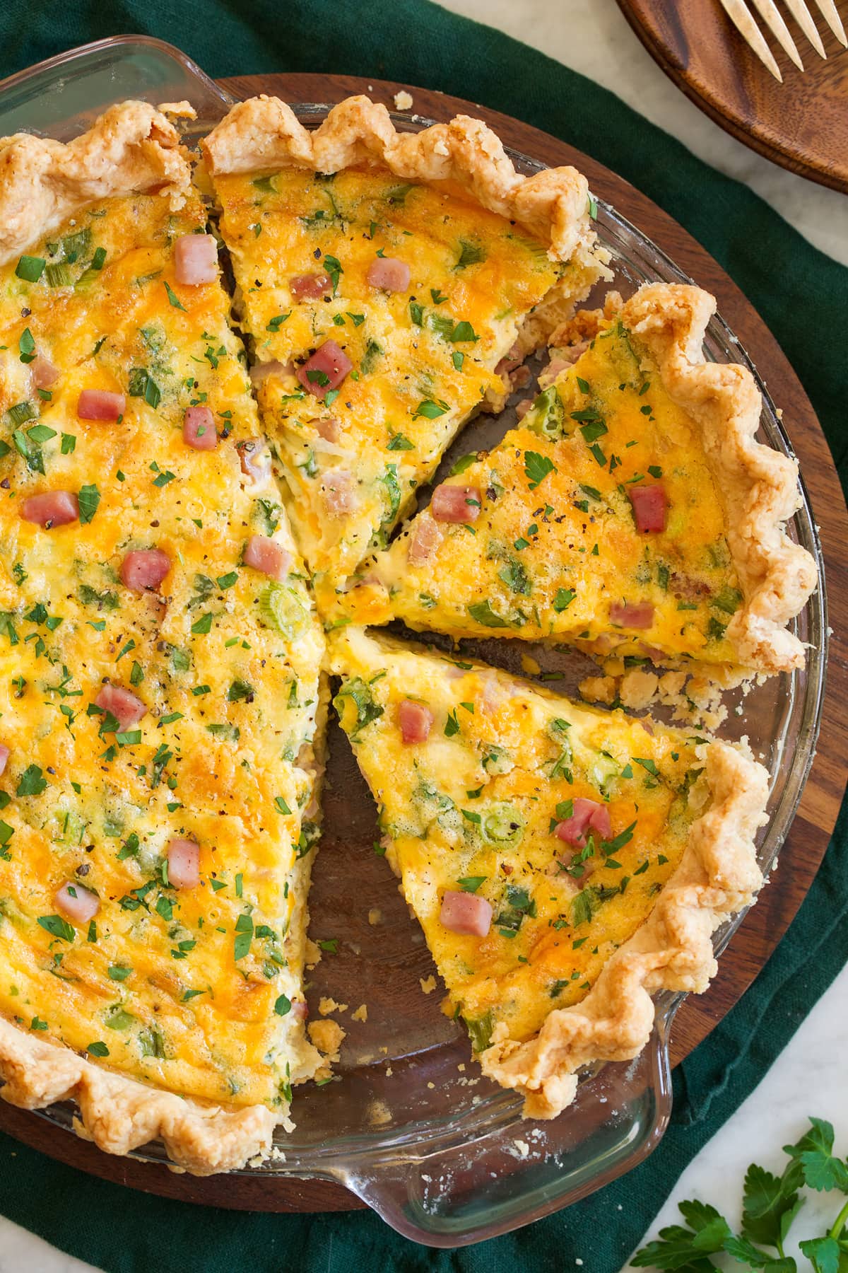 Overhead photo of sliced quiche in a glass pie pan.