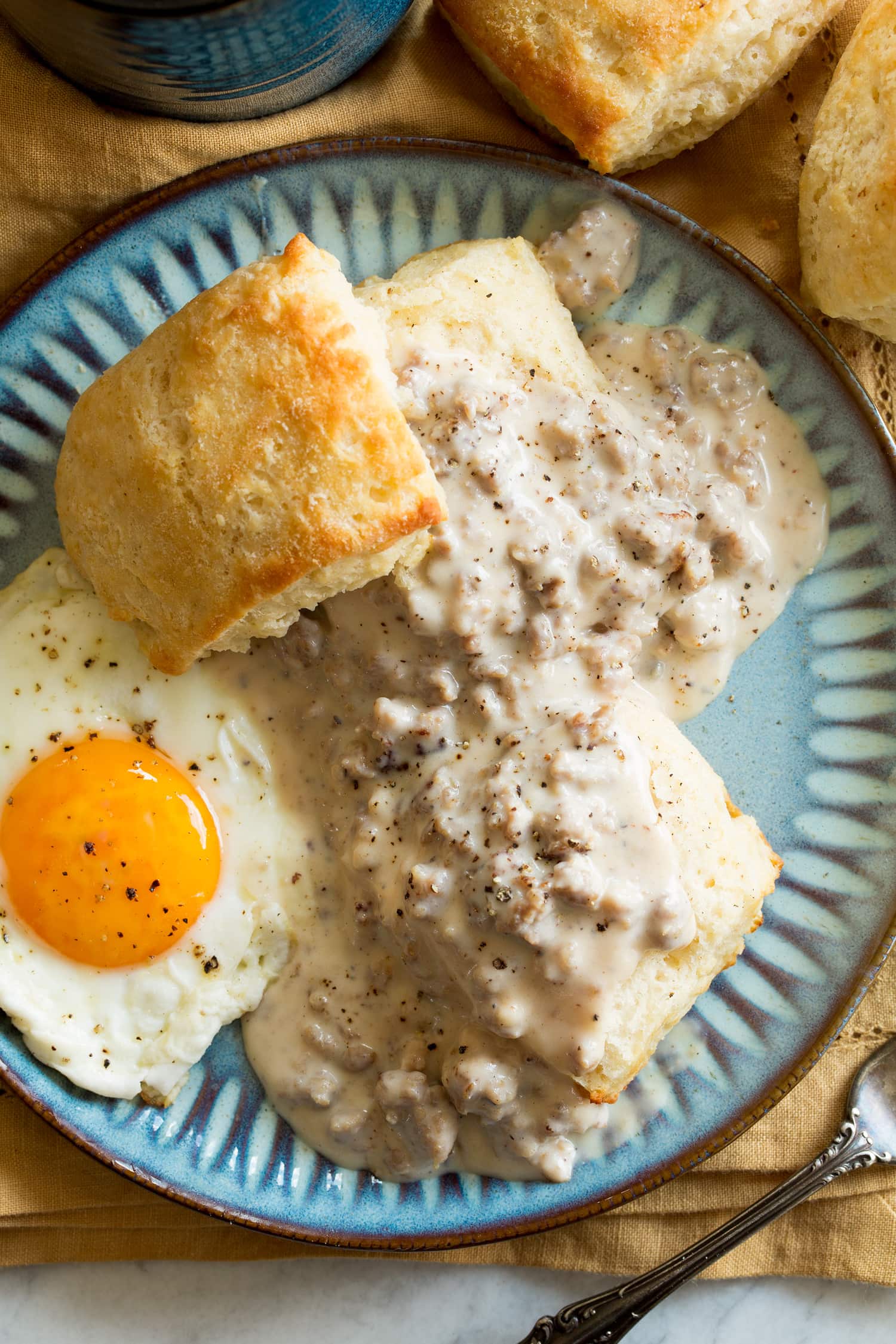 Biscuits and gravy served with a sunny side egg as a serving suggestion.