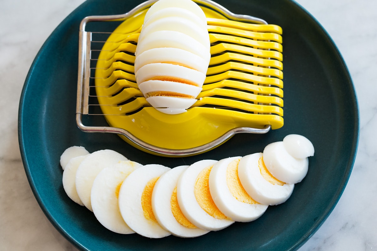 Steamed eggs shown after being sliced in an egg slicer.