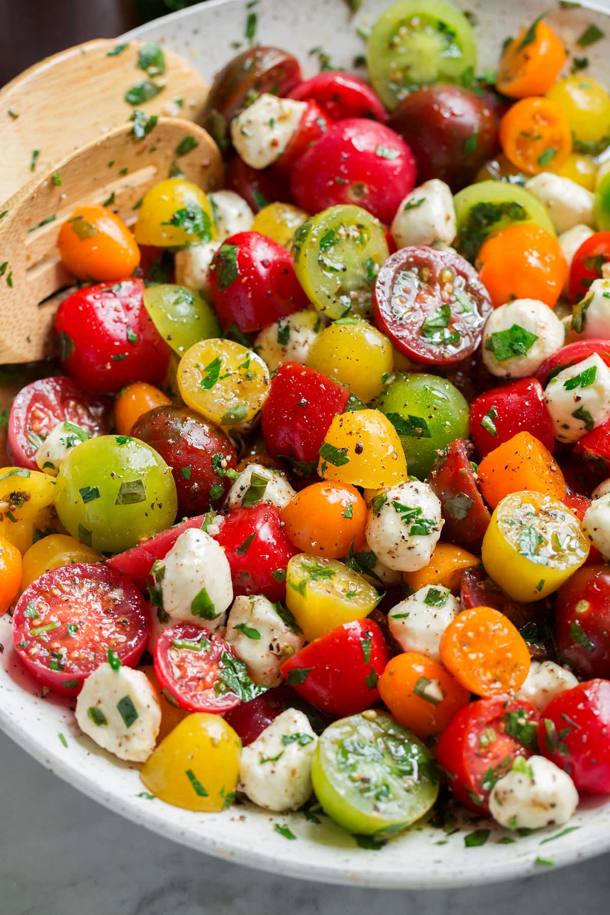 Image showing tomato salad from a side angle in a serving bowl.