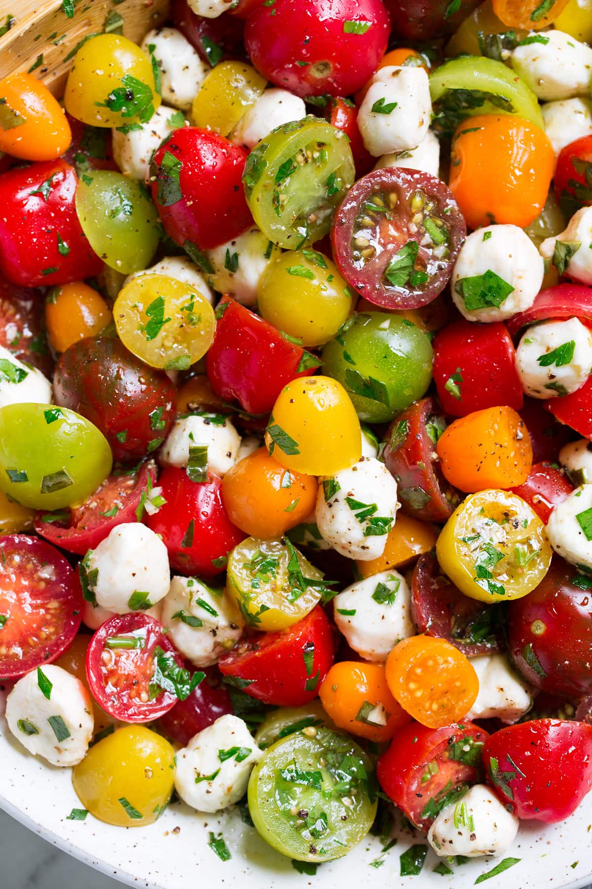 Close up image of tomato salad in a ceramic bowl.